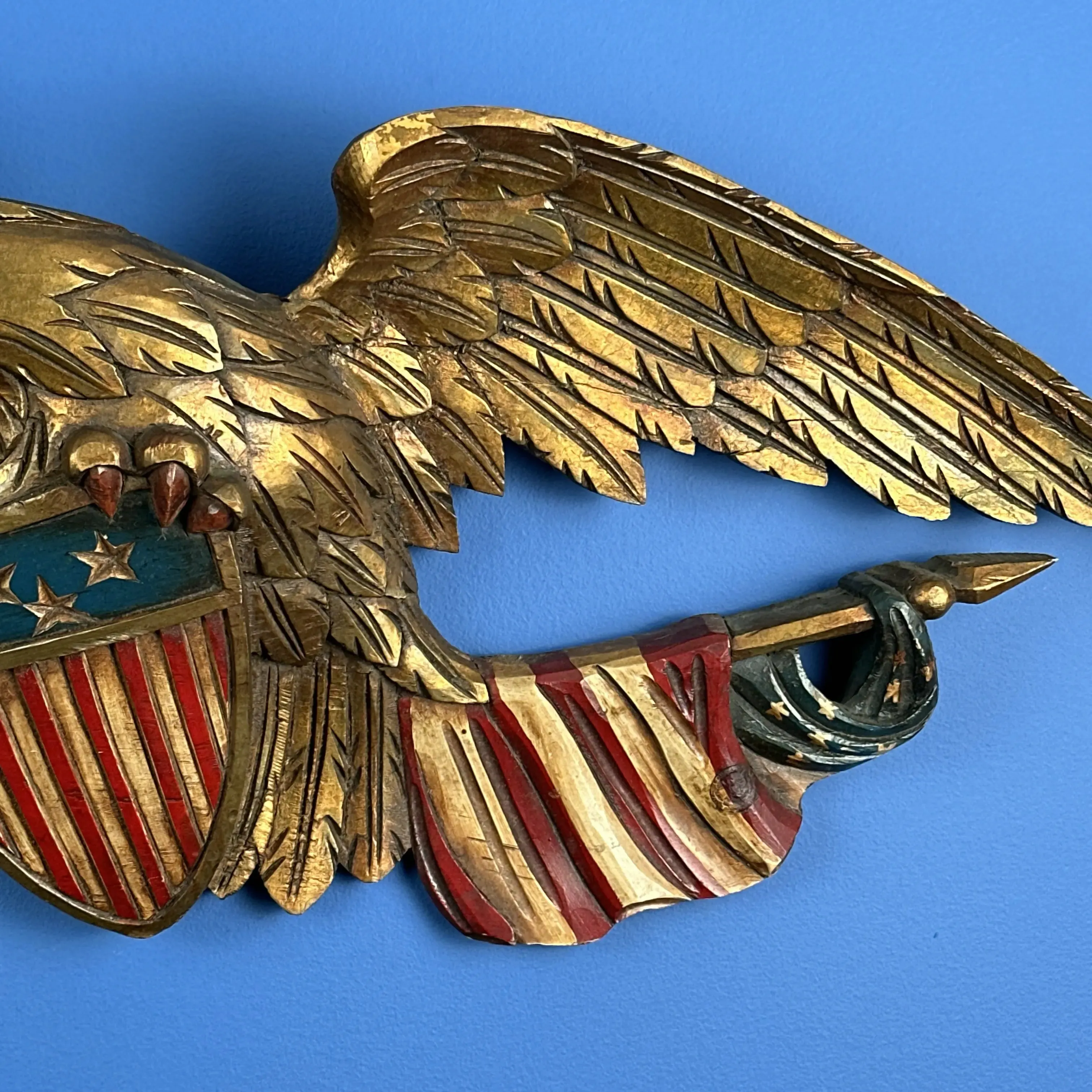 Carved wooden eagle with a shield and two flags — 29” wide